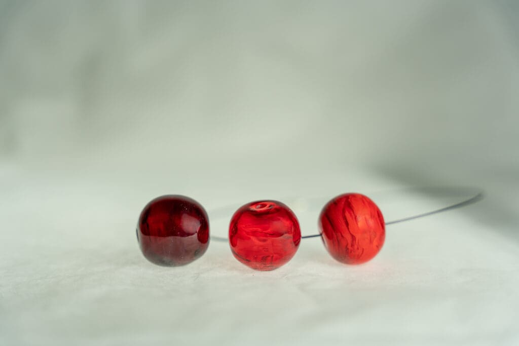 Ühtlasel taustal kataloogi tootefoto_klaasist helmed_punased